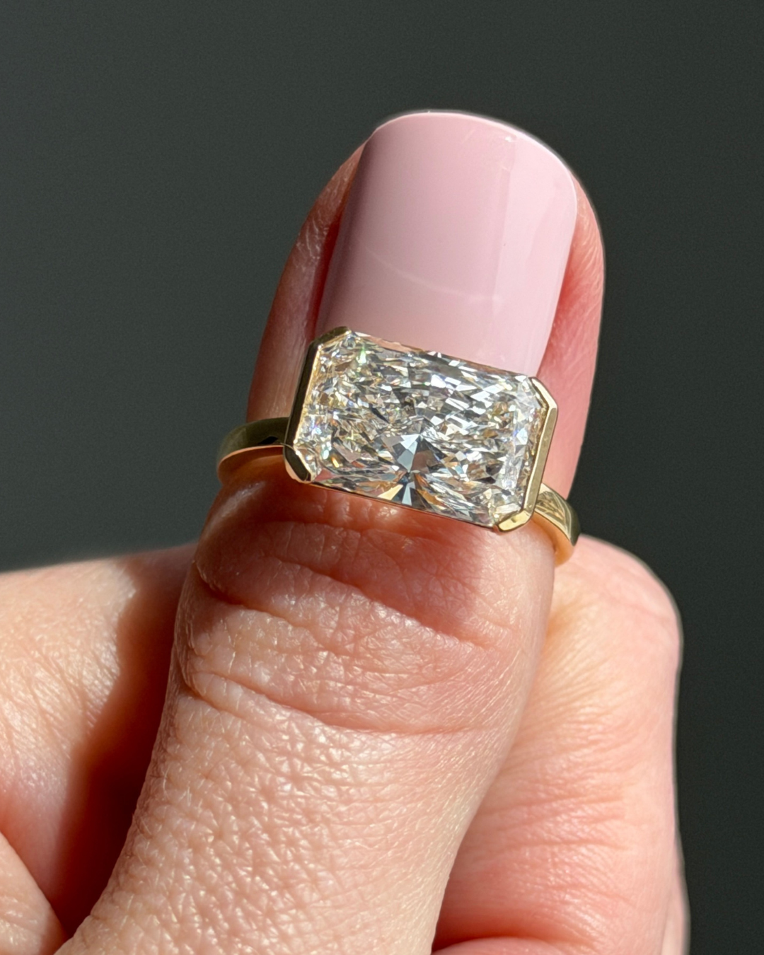 East west radiant cut diamond ring in yellow gold
