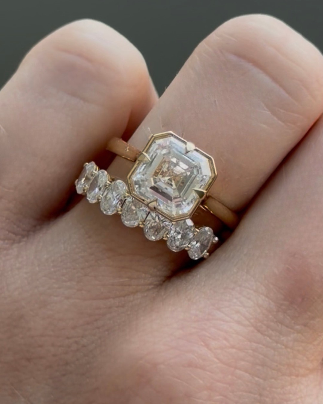 Asscher cut ring stacked with an oval diamond band