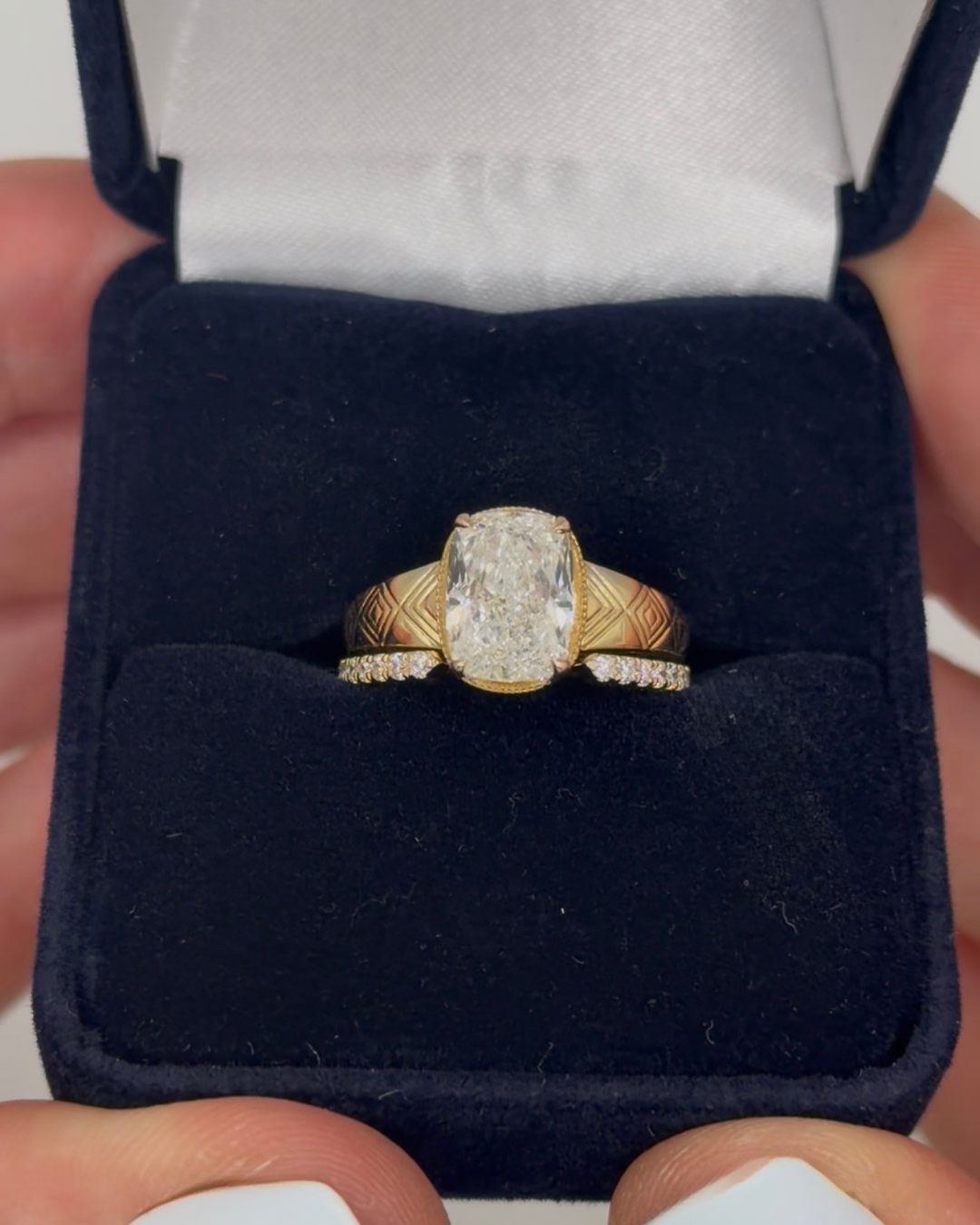 Elongated cushion diamond ring with engraved yellow gold band